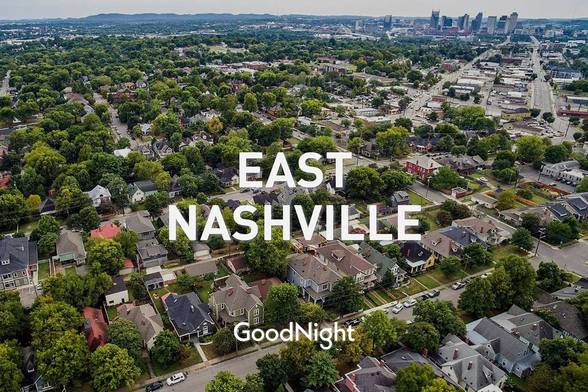 A welcoming view of neighborhood greenery, residential homes, and a distant city skyline. The scene suggests a vibrant, community-oriented area with outdoor spaces perfect for families to explore and enjoy together.