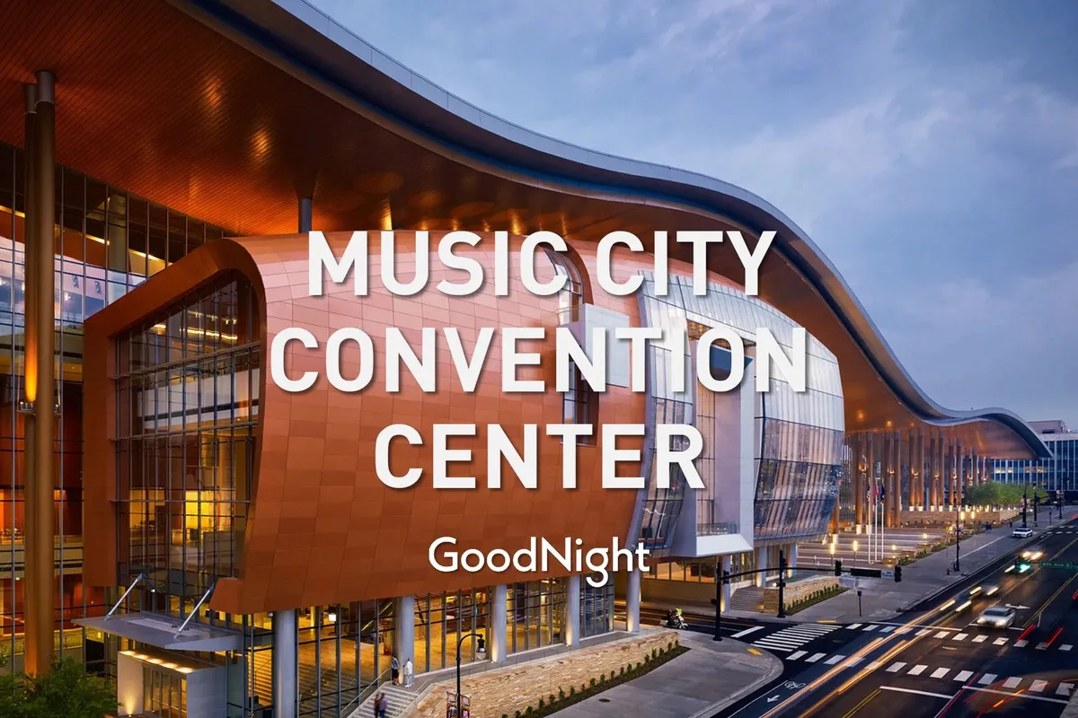 This image captures the modern curved roofline and glass façade of Music City Center, one of Nashville's prominent downtown business venues. There are architectural details visible that convey a sense of professionalism and possibility for events, conferences, and networking.